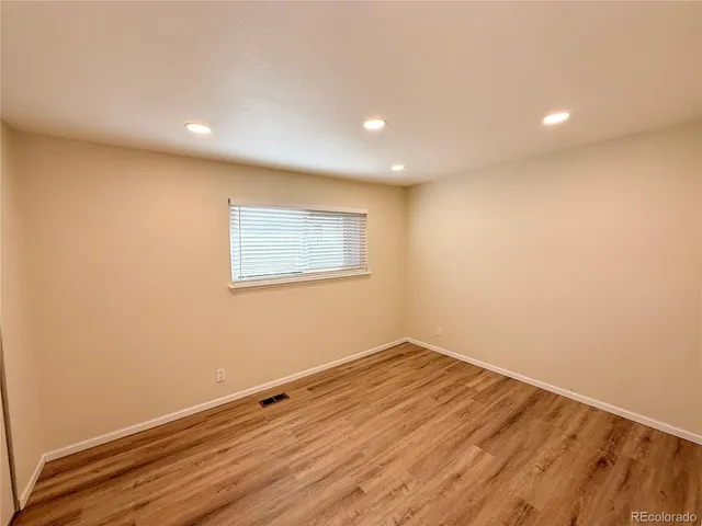 a view of room with wooden floor and fan