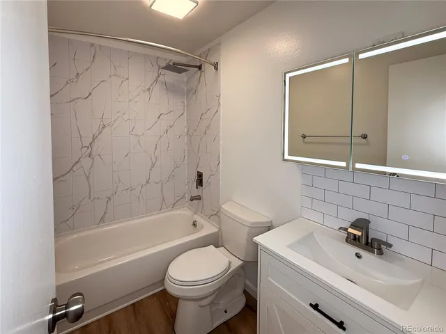 a bathroom with a sink toilet and shower
