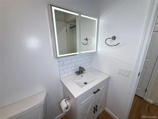a bathroom with a sink mirror and vanity