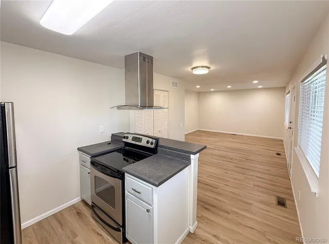 a kitchen that has a sink and a stove in it