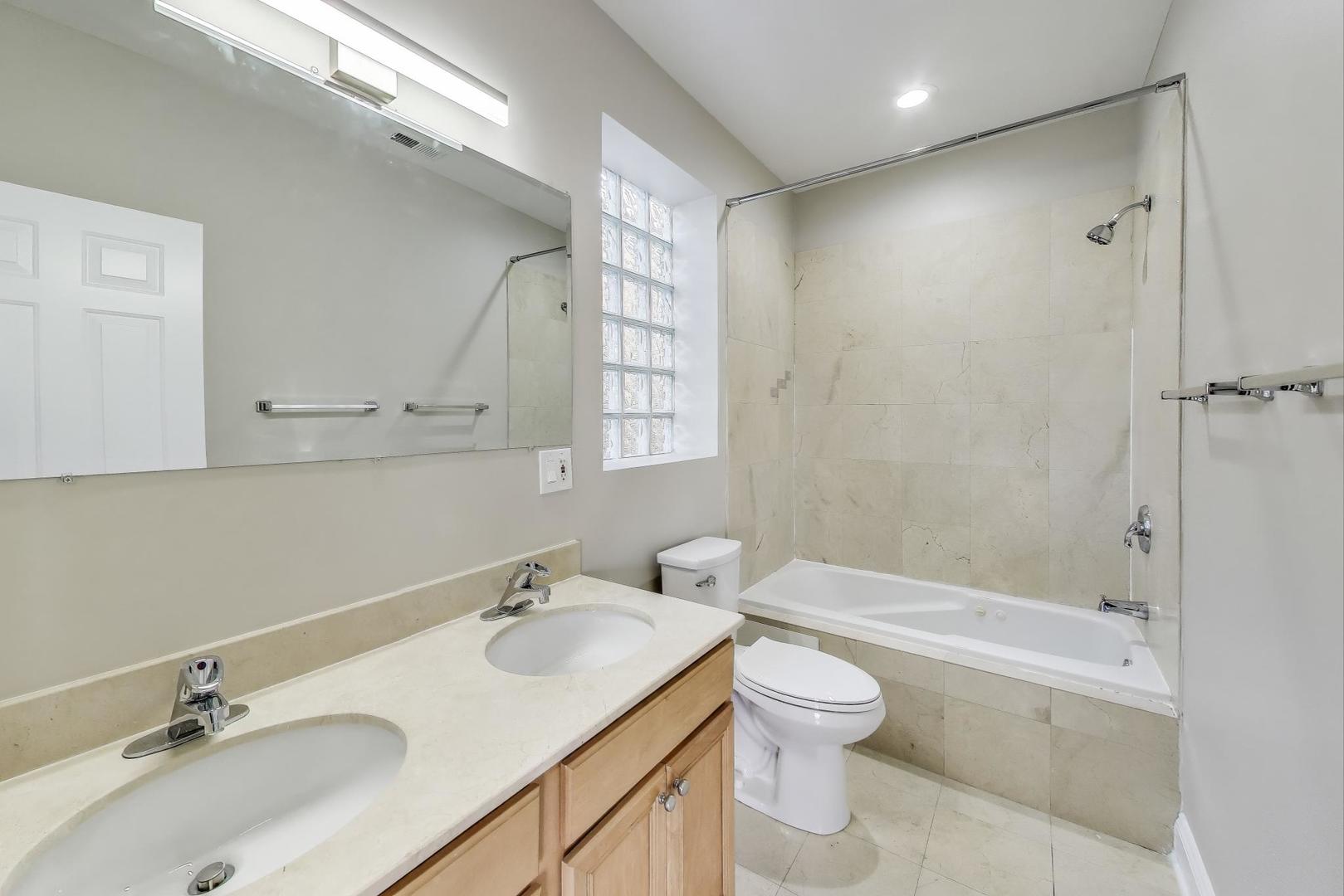 1308 West Fillmore Street, Unit 3 Chicago, IL 60607 - Photo 14 of 23 a bathroom with a granite countertop sink toilet and shower