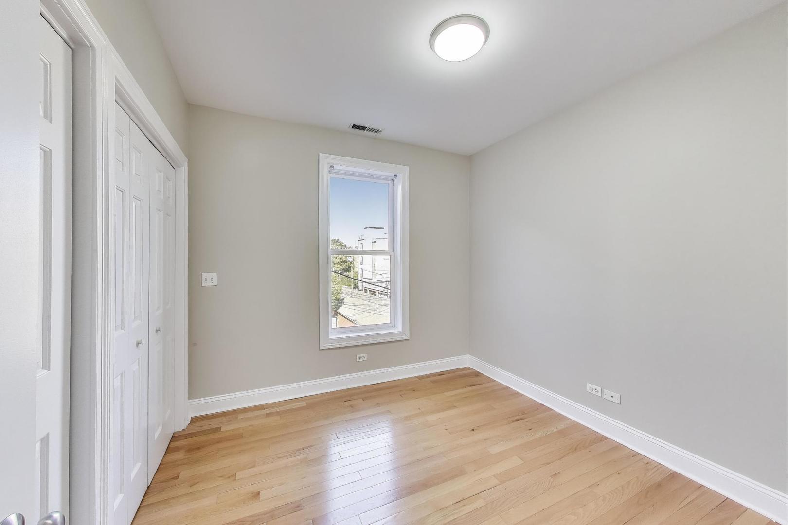 1308 West Fillmore Street, Unit 3 Chicago, IL 60607 - Photo 17 of 23 an empty room with wooden floor and windows