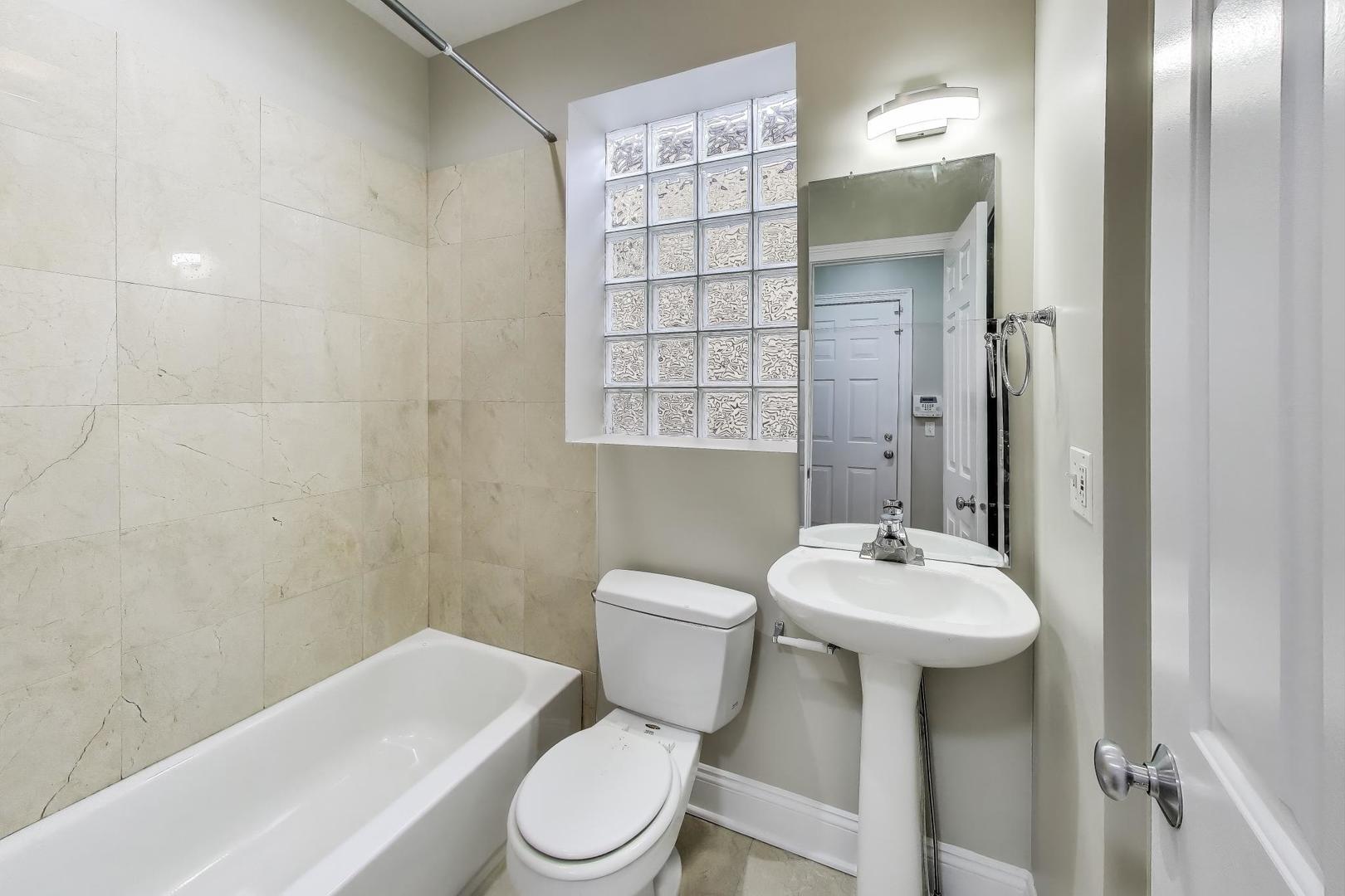 1308 West Fillmore Street, Unit 3 Chicago, IL 60607 - Photo 19 of 23 a bathroom with a sink toilet and shower