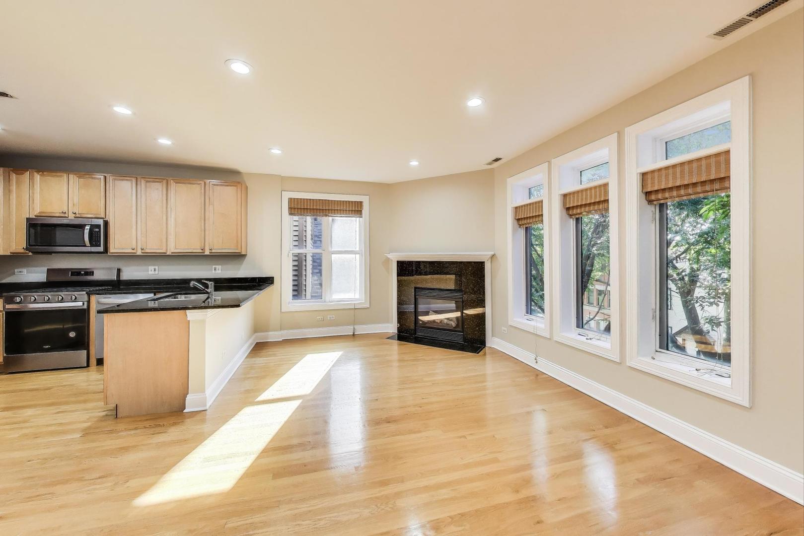 1308 West Fillmore Street, Unit 3 Chicago, IL 60607 - Photo 5 of 23 a kitchen with granite countertop a stove top oven a sink a counter space and cabinets