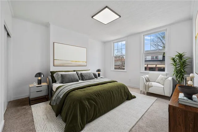 a bedroom with a large bed and a couch