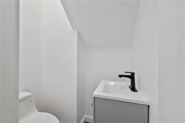 a bathroom with a sink a toilet and mirror