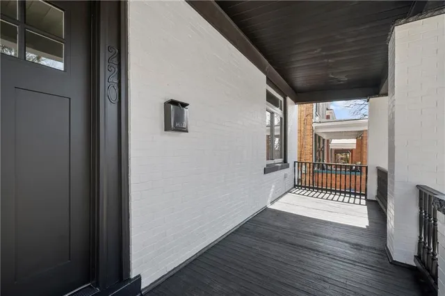 a view of a porch with wooden floor and a window