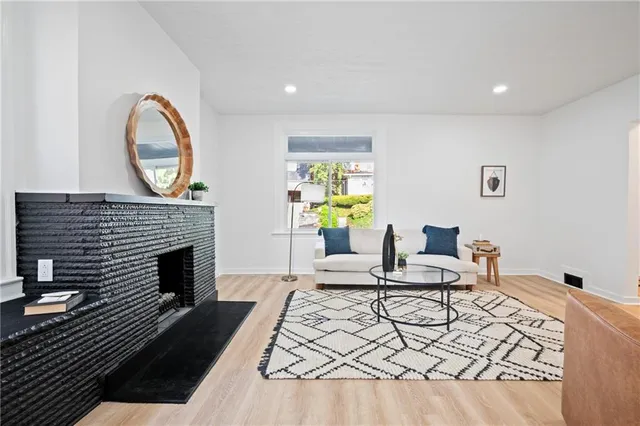 a living room with furniture a fireplace and a table