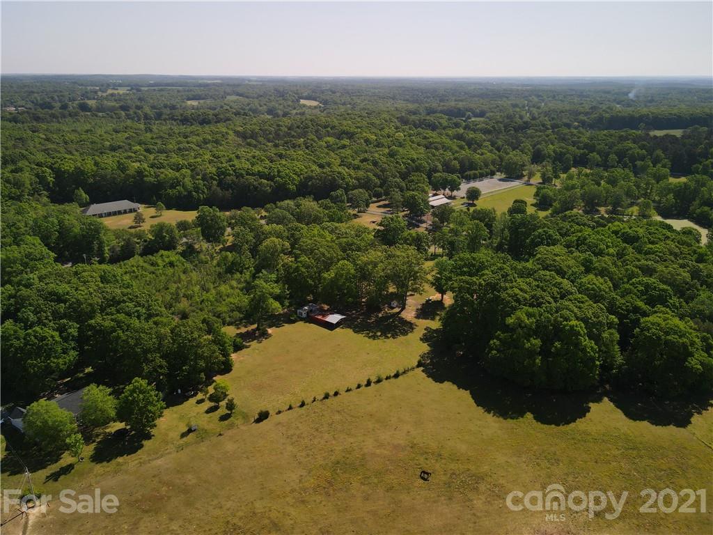 3003 Trinity Church Road Monroe, NC 28112 - Photo 22 of 36 an aerial view of residential houses with outdoor space and trees