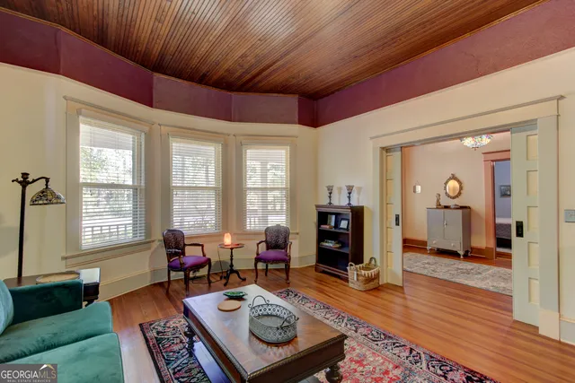 a living room with furniture a wooden floor and a window