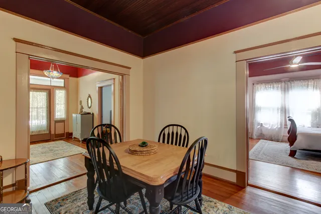 a view of a dining room with furniture and wooden floor