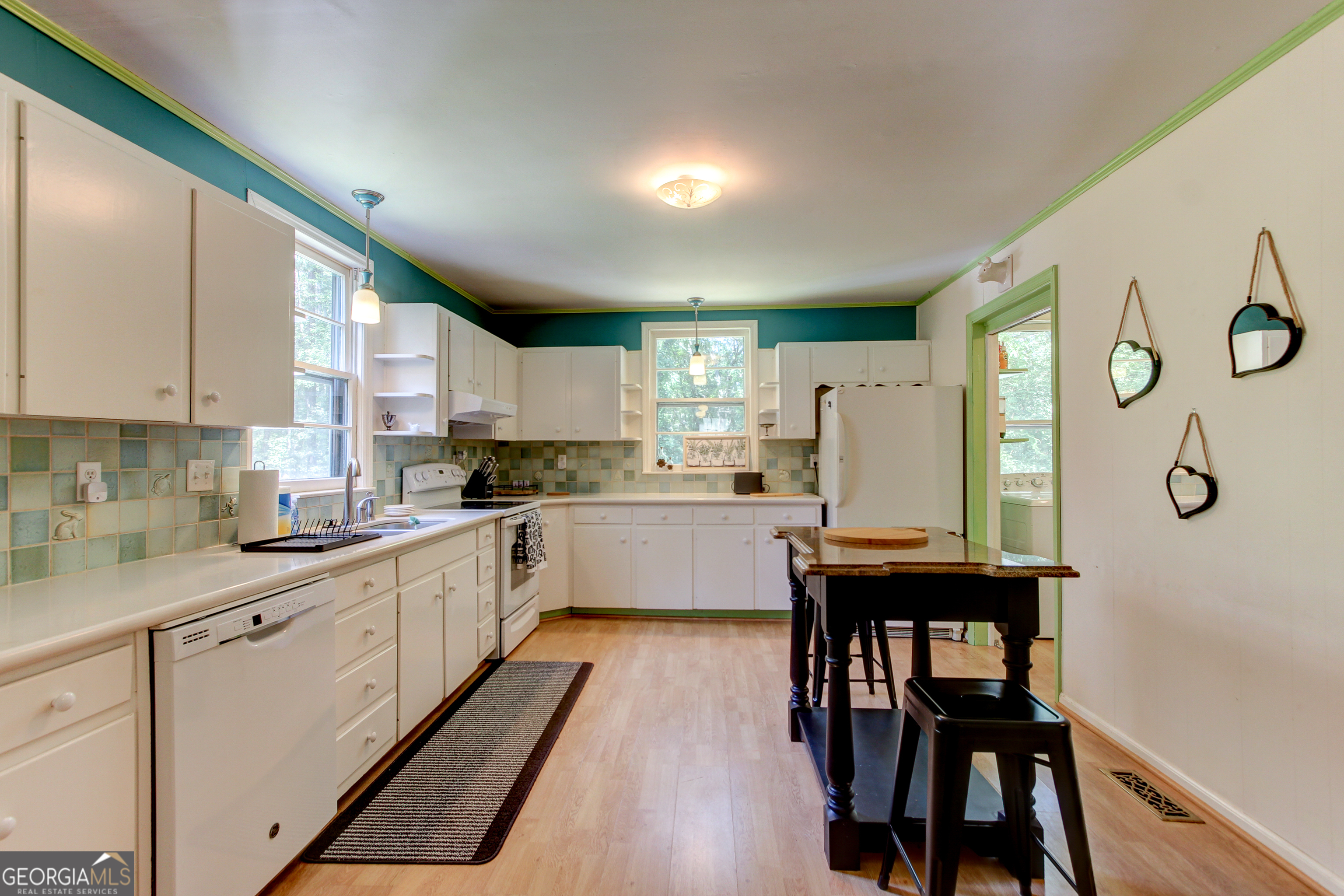 127 Wilkins Road Fayetteville, GA 30214 - Photo 37 of 53 a kitchen with stainless steel appliances granite countertop a white cabinets and wooden floor