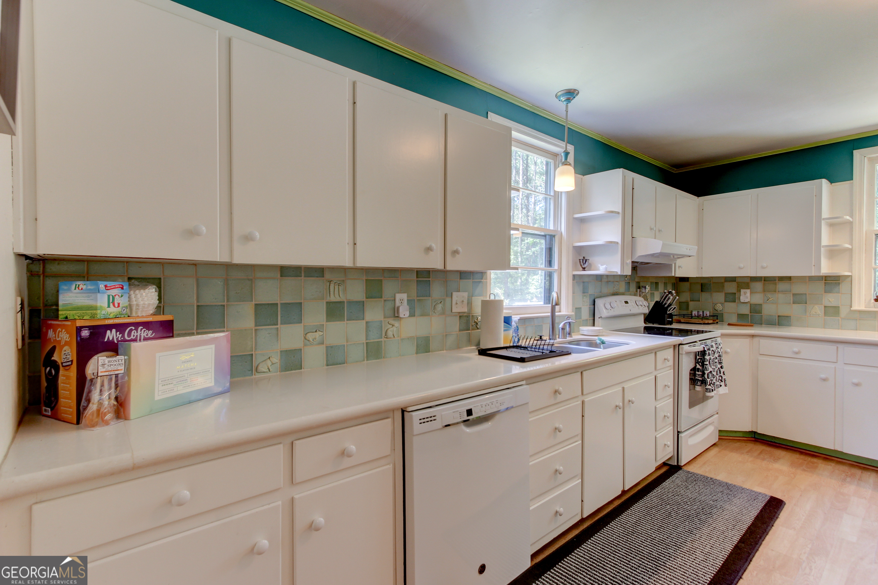 127 Wilkins Road Fayetteville, GA 30214 - Photo 38 of 53 a kitchen with cabinets appliances a sink and a window