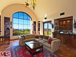 1485 Decker Road Malibu, CA 90265 - Photo 1 of 1 a living room with furniture and a floor to ceiling window