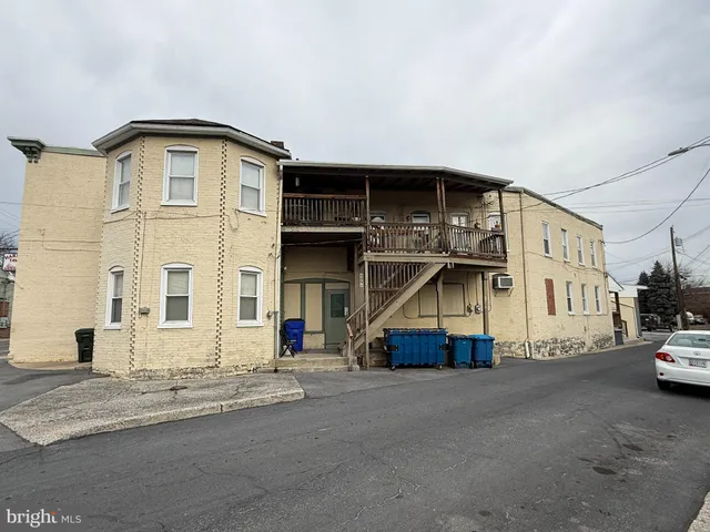 a view of large building with car parked