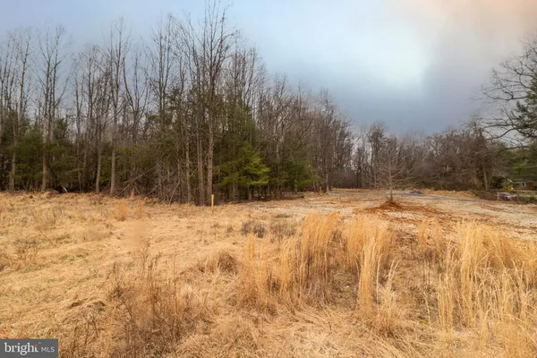a view of yard covered with snow in front of house