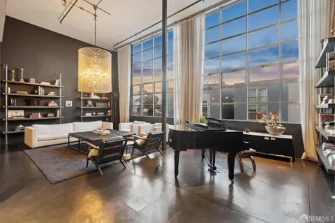 a living room with furniture a floor to ceiling window and a flat screen tv