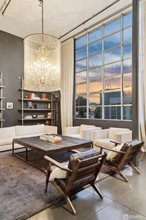 a living room with furniture a rug and a large window