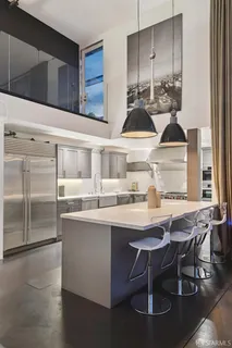 a kitchen with stainless steel appliances granite countertop a sink and a stove