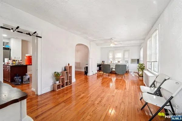a living room with furniture and a wooden floor