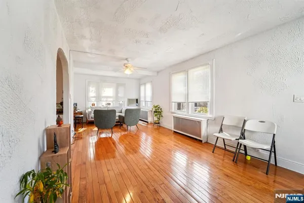 a living room with furniture and a wooden floor
