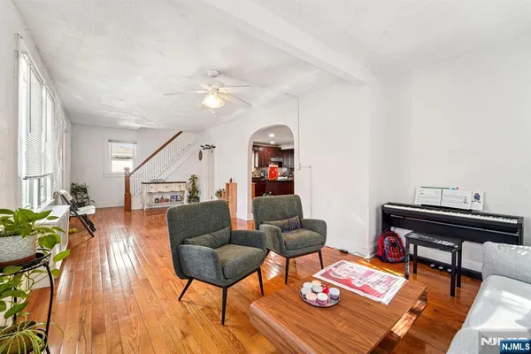 a living room with furniture and wooden floor
