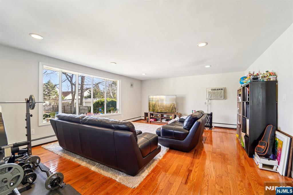 359 Bogert Avenue Ridgewood, NJ 07450 - Photo 10 of 17 a living room with furniture window and a flat screen tv