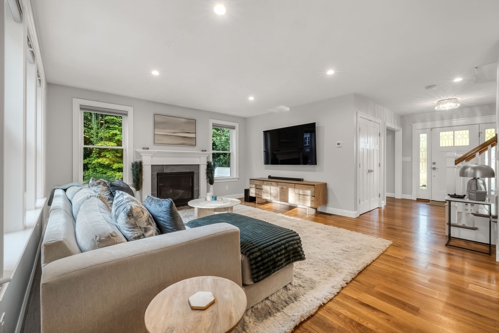 540 Pulaski Boulevard Bellingham, MA 02019 - Photo 13 of 42 a living room with furniture flat screen tv and a fireplace