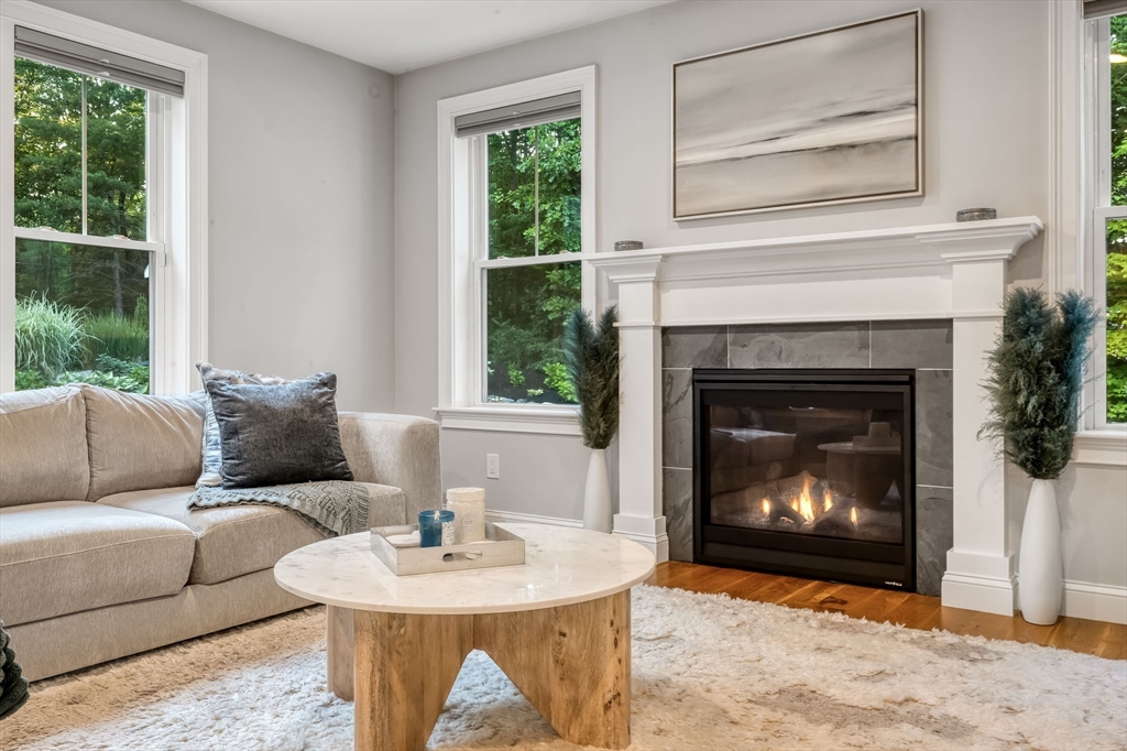 540 Pulaski Boulevard Bellingham, MA 02019 - Photo 14 of 42 a living room with furniture a window and a fireplace