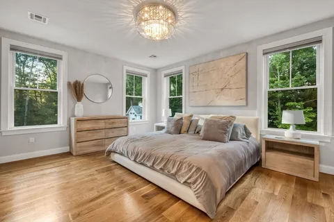 a bedroom with a large bed and a large window