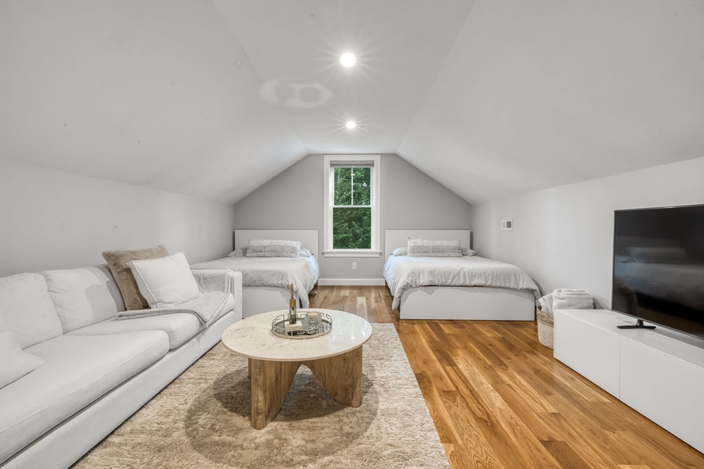 540 Pulaski Boulevard Bellingham, MA 02019 - Photo 29 of 42 a living room with furniture and a flat screen tv
