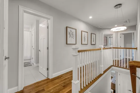a view of a hallway with entryway door