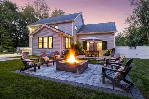 a front view of house with a garden and patio