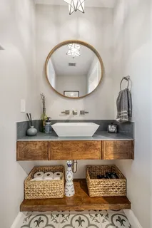 a living room with furniture and a mirror