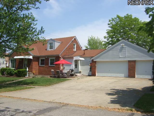 9239 Snow Road Cleveland, OH 44130 - Photo 2 of 24 Side elevation. Driveway is on Elmore Dr. Enjoy summer gatherings on the patio area. The 3 car garage is great for extra storage!