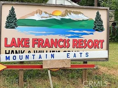 a view of a wooden house with a sign broad