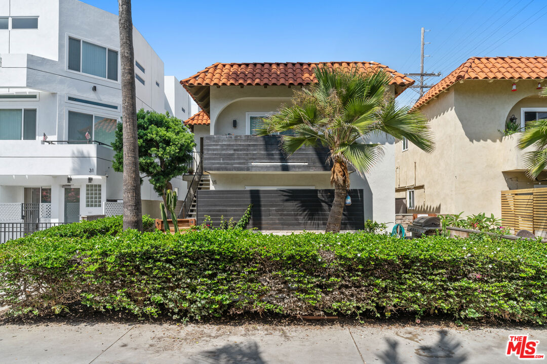 35 Catamaran Street, Unit 3 Marina del Rey, CA 90292 - Photo 2 of 11 a front view of a house with a yard and potted plants