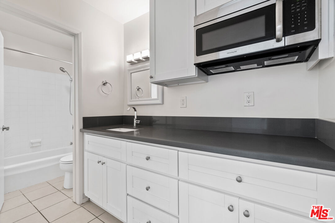 35 Catamaran Street, Unit 3 Marina del Rey, CA 90292 - Photo 6 of 11 a kitchen with stainless steel appliances a sink and a microwave