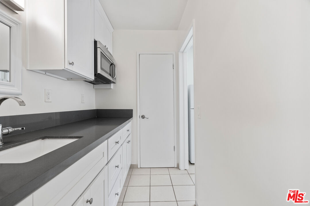 35 Catamaran Street, Unit 3 Marina del Rey, CA 90292 - Photo 8 of 11 a kitchen with white cabinets and a sink