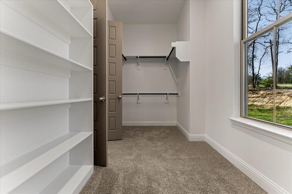131 Spring Valley Road Paradise, TX 76073 - Photo 26 of 40 a view of walk in closet with empty racks