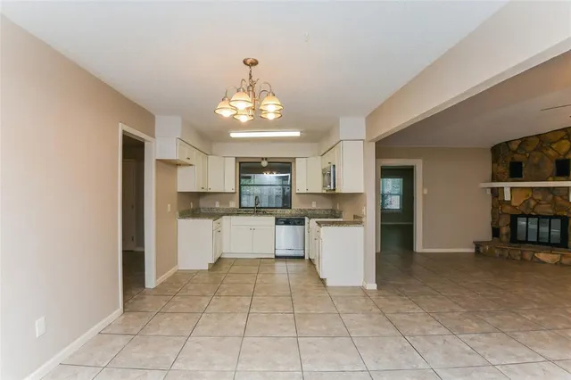 a large kitchen with cabinets and stainless steel appliances