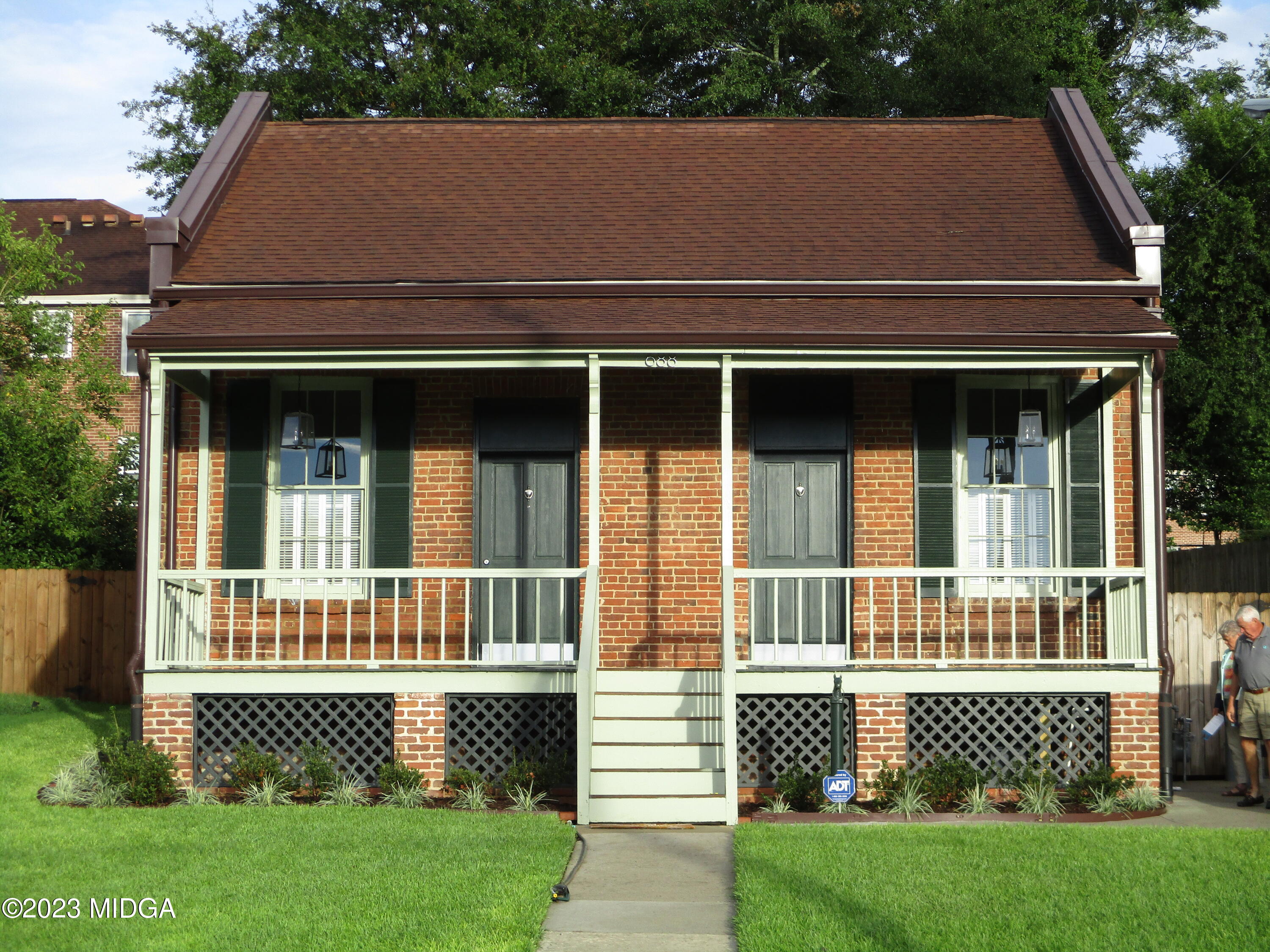 688 Monroe Street Macon, GA 31201 - Photo 1 of 26 a front view of a house with a garden