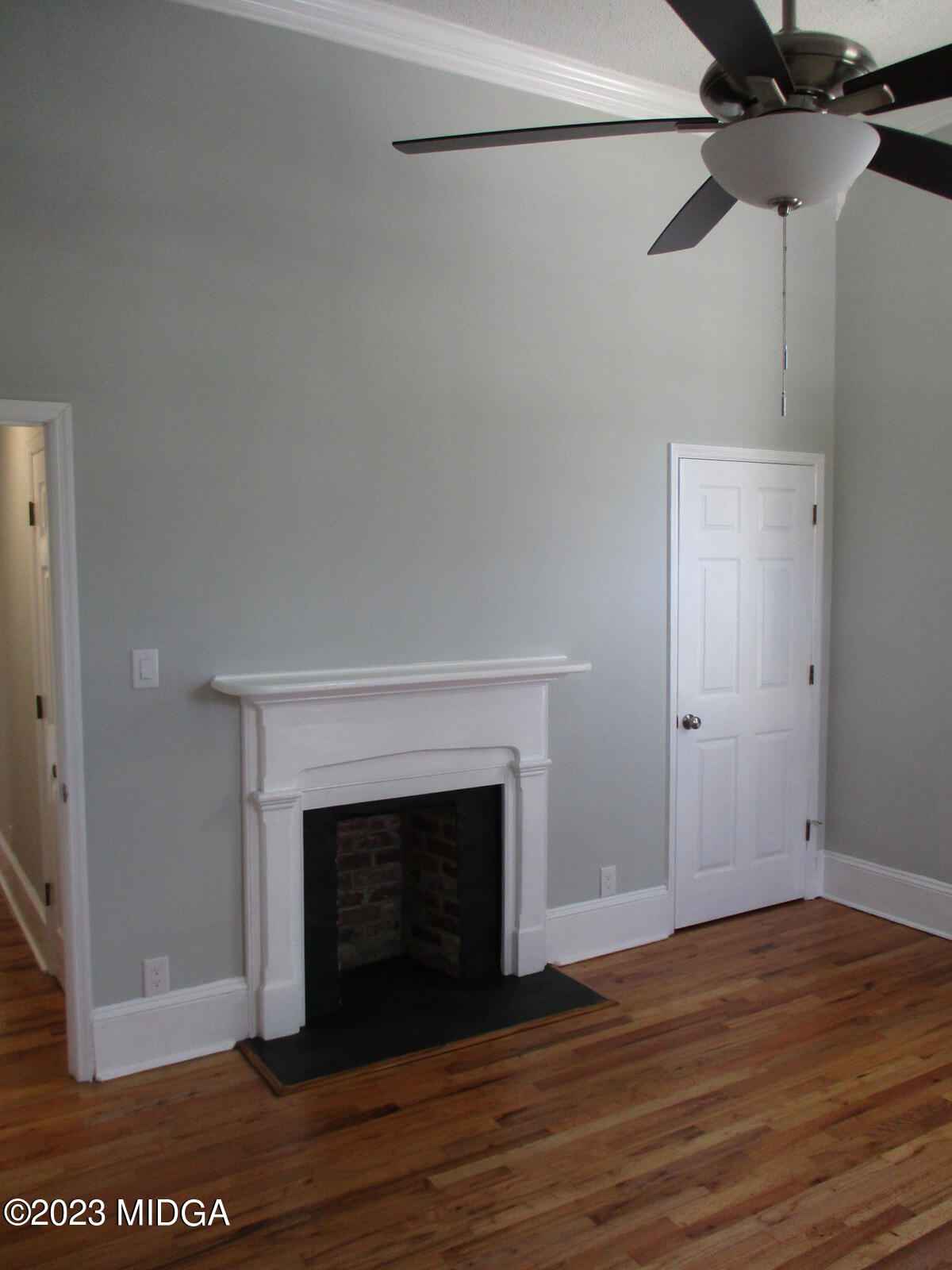 688 Monroe Street Macon, GA 31201 - Photo 17 of 26 a view of a room with wooden floor and a fireplace
