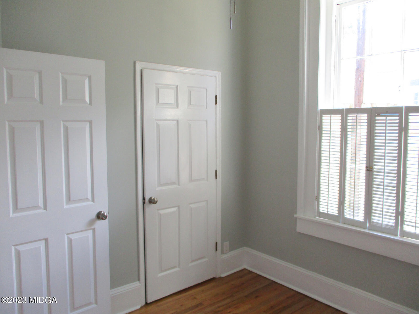 688 Monroe Street Macon, GA 31201 - Photo 18 of 26 a view of an empty room with wooden floor and a window