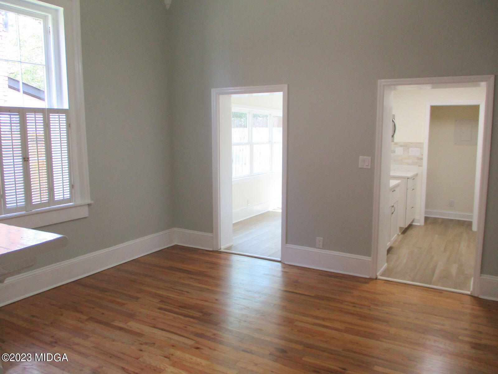 688 Monroe Street Macon, GA 31201 - Photo 21 of 26 an empty room with wooden floor and windows