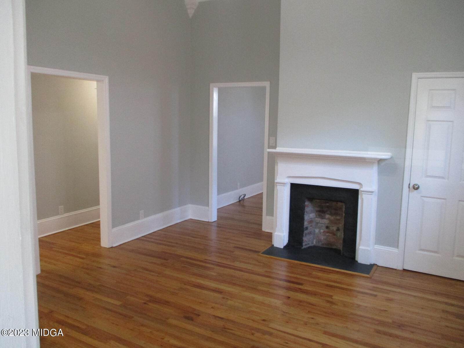 688 Monroe Street Macon, GA 31201 - Photo 23 of 26 a view of an empty room with wooden floor and a fireplace