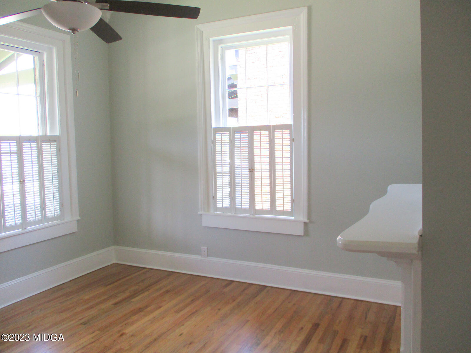688 Monroe Street Macon, GA 31201 - Photo 3 of 26 an empty room with wooden floor and windows