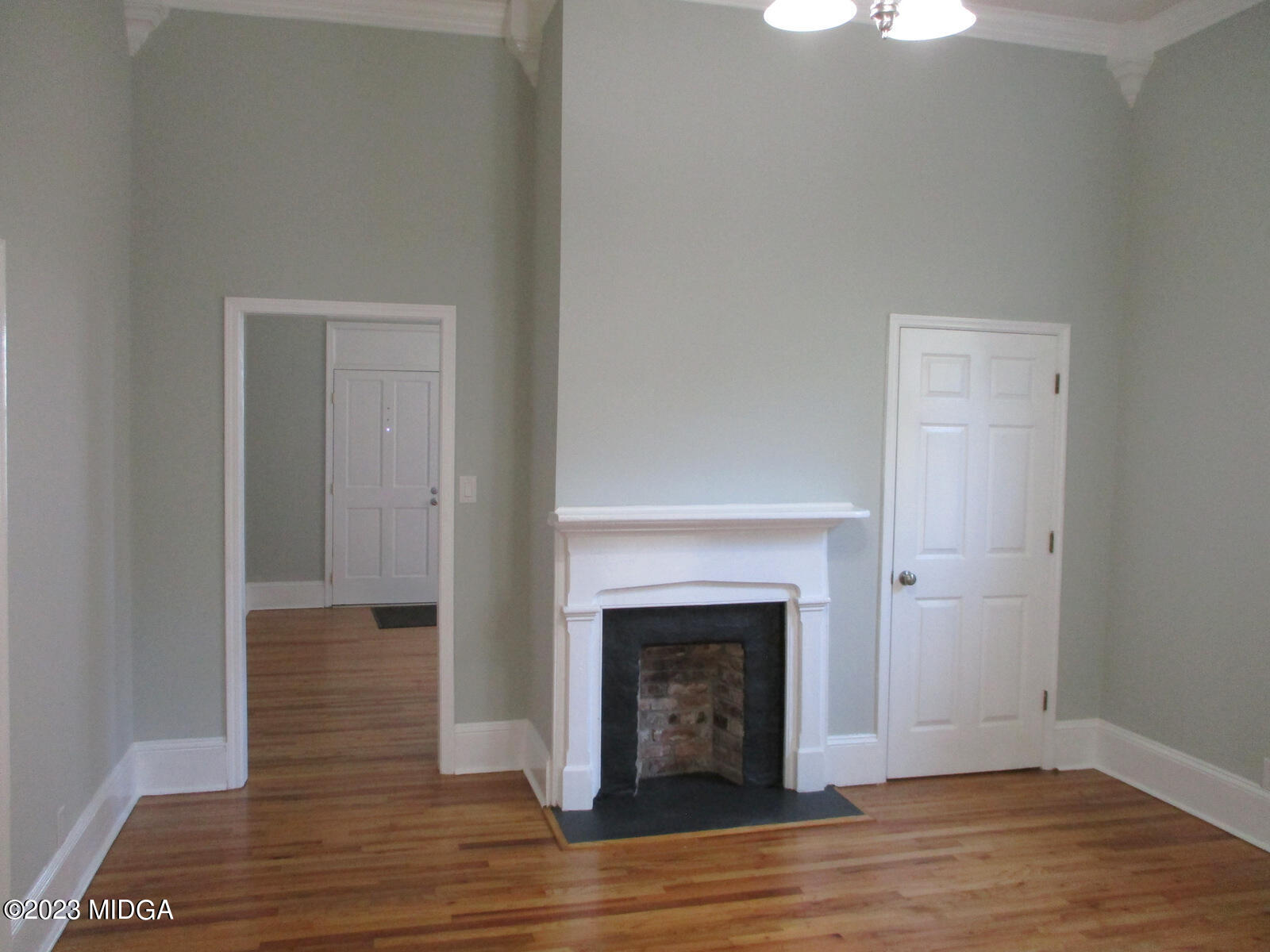 688 Monroe Street Macon, GA 31201 - Photo 5 of 26 a view of a livingroom with wooden floor and a fireplace