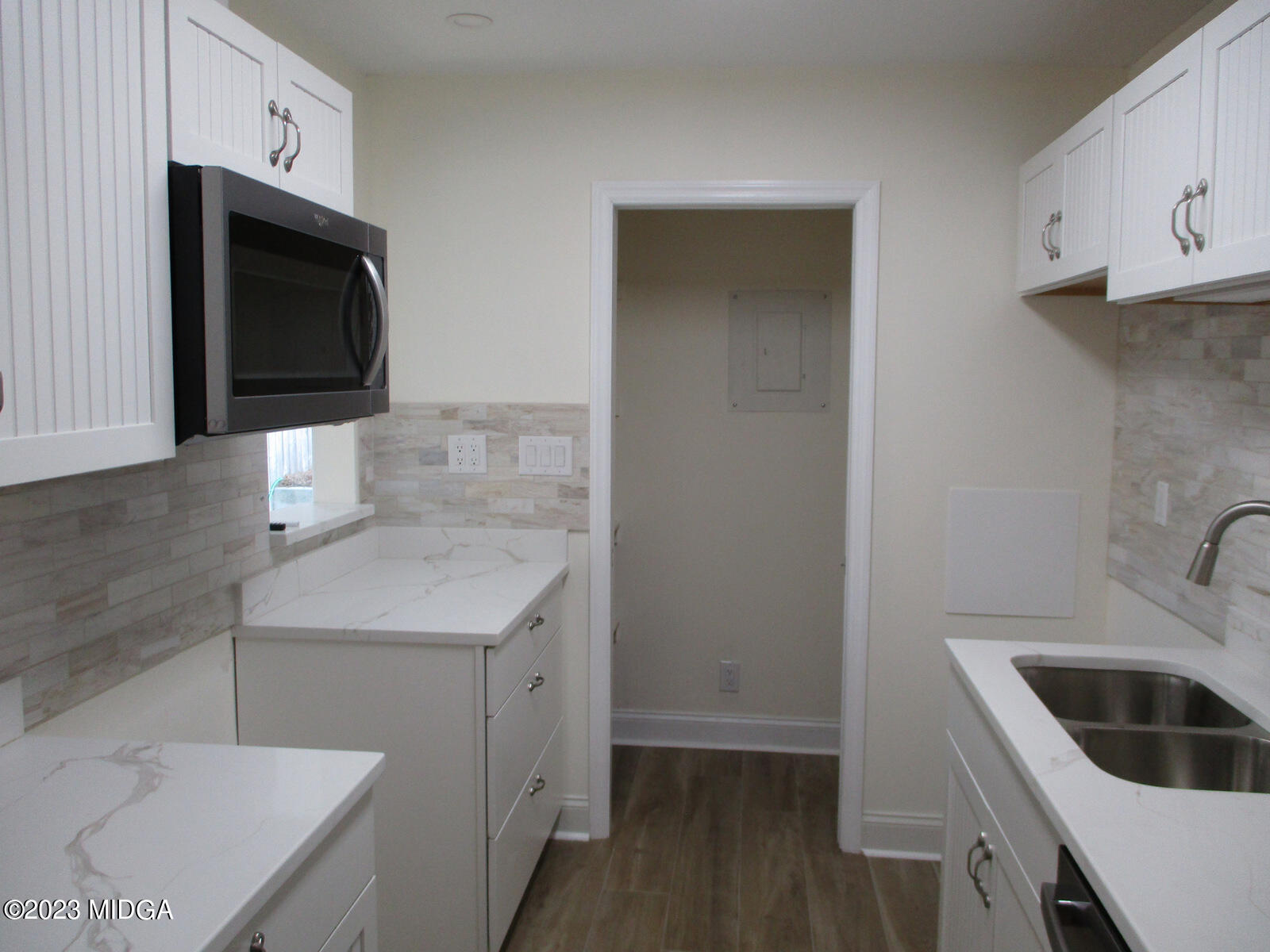 688 Monroe Street Macon, GA 31201 - Photo 6 of 26 a kitchen with a sink a stove and cabinets