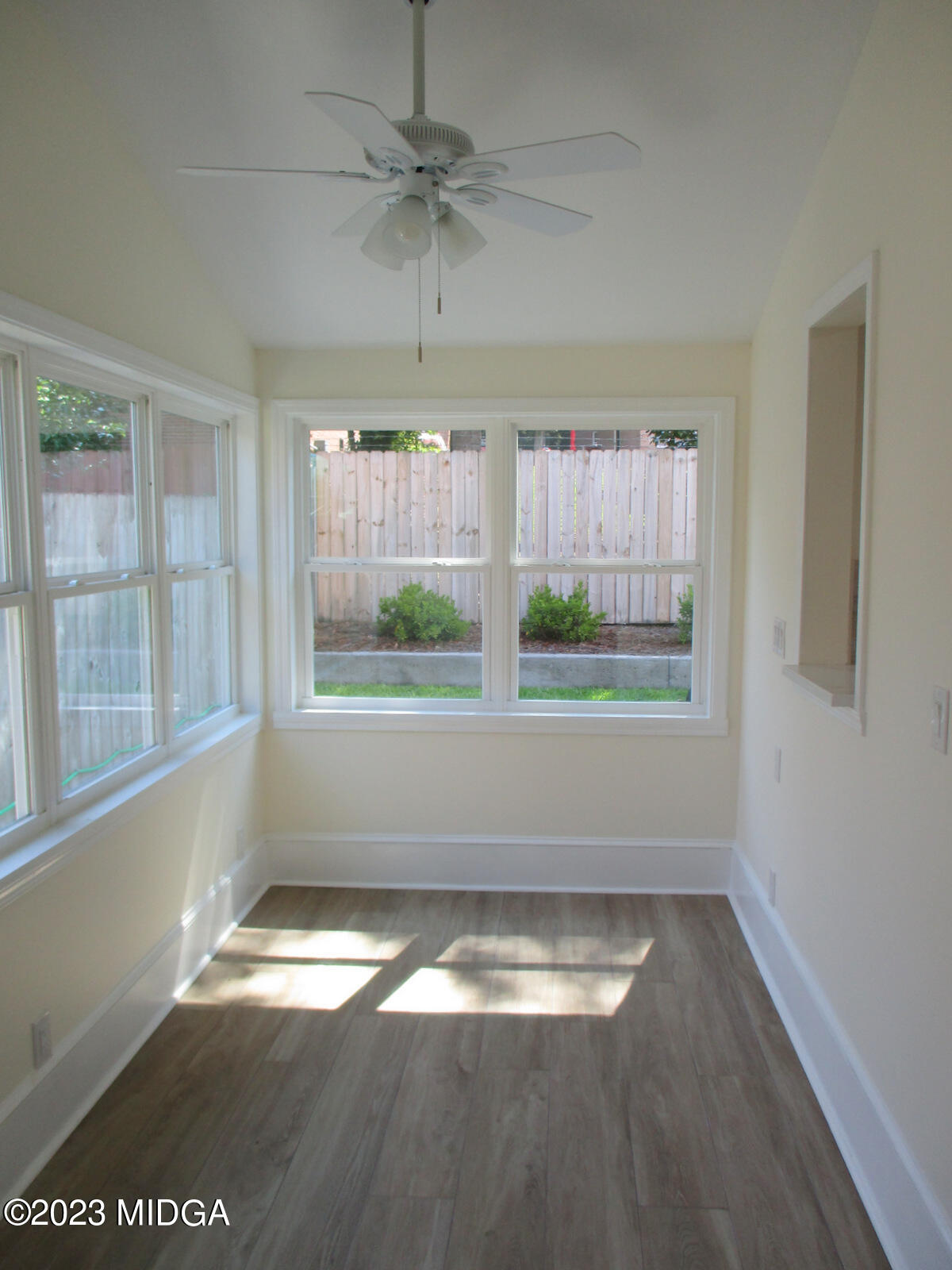 688 Monroe Street Macon, GA 31201 - Photo 9 of 26 a view of empty room with wooden floor and fan